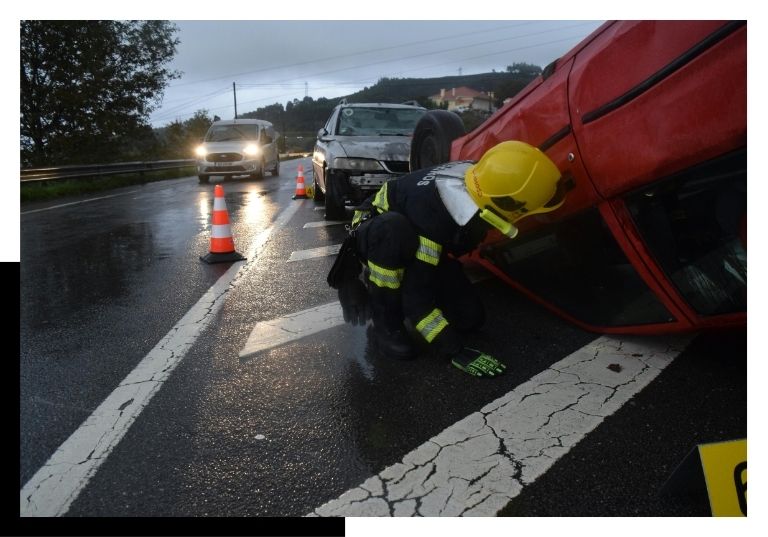 firefighter helping a flipped car
