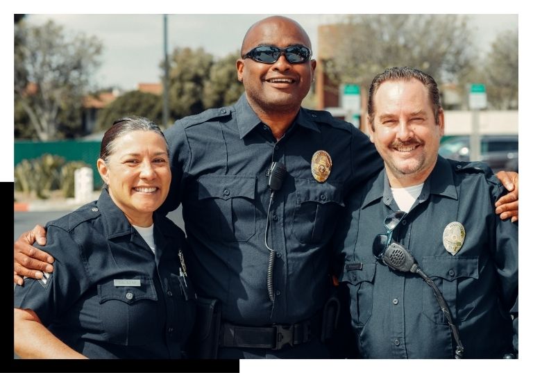 police officers with arms around each other smiling